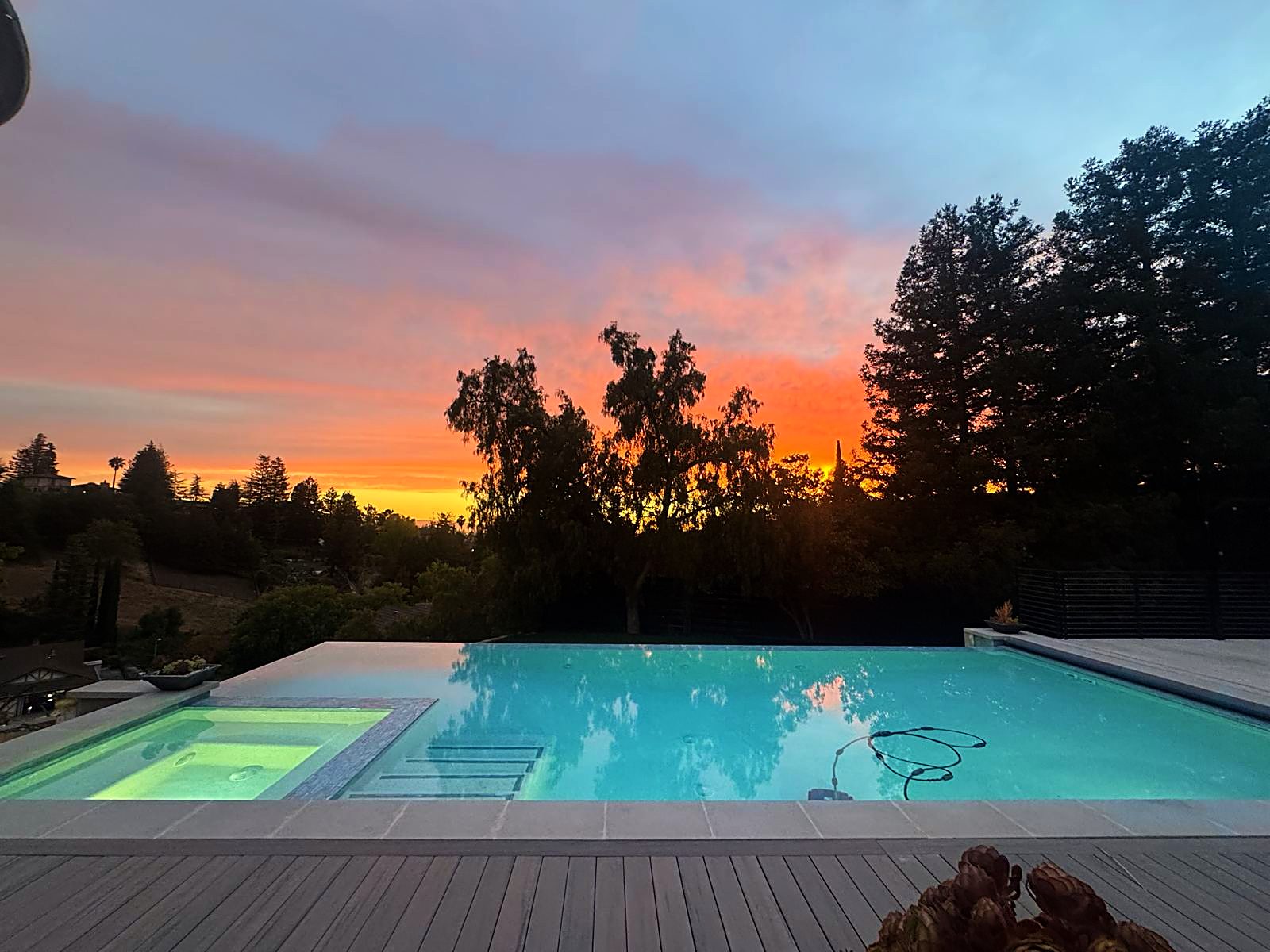 Hillside vanishing-edge pool and spa at sunset